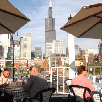 People eating outside with the chicago skyline in the distance