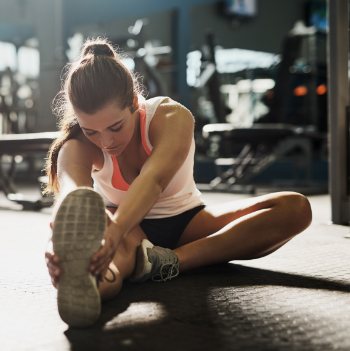 Woman Stretching at the Gym